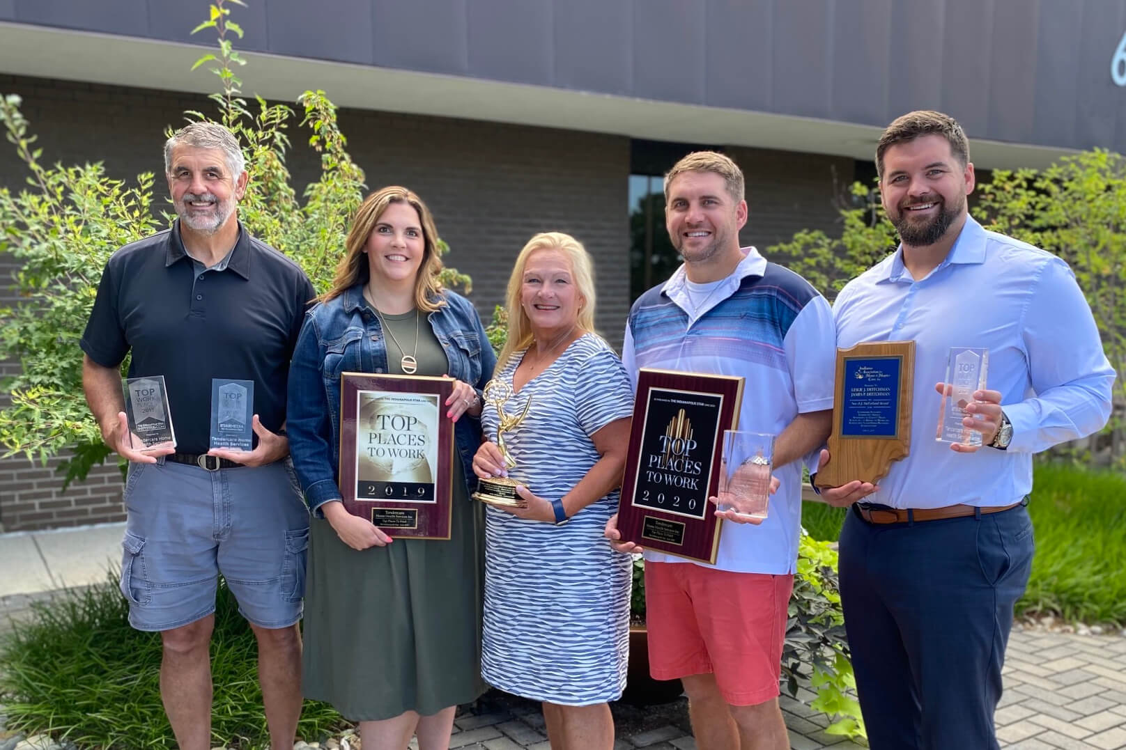 Jim, Kelly, Leslie, Kyle, and Eric–Tendercare's ownership team–holding various awards they've been given